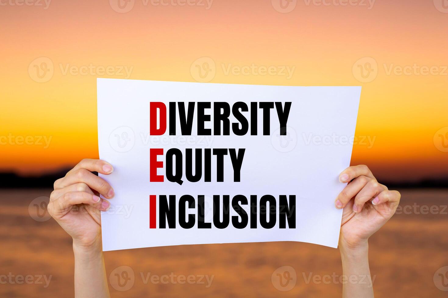 Diversity equity and inclusion words written on white paper with blurry lake background. Conceptual diversity equity inclusion DEI symbol. Copy space. photo