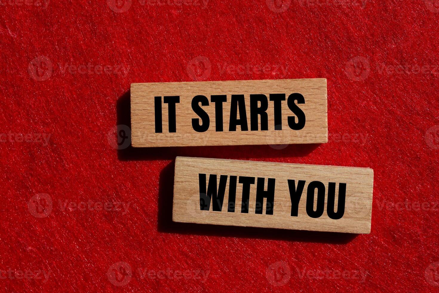 It starts with you message written on wooden blocks with red background. Conceptual it starts with you symbol. photo