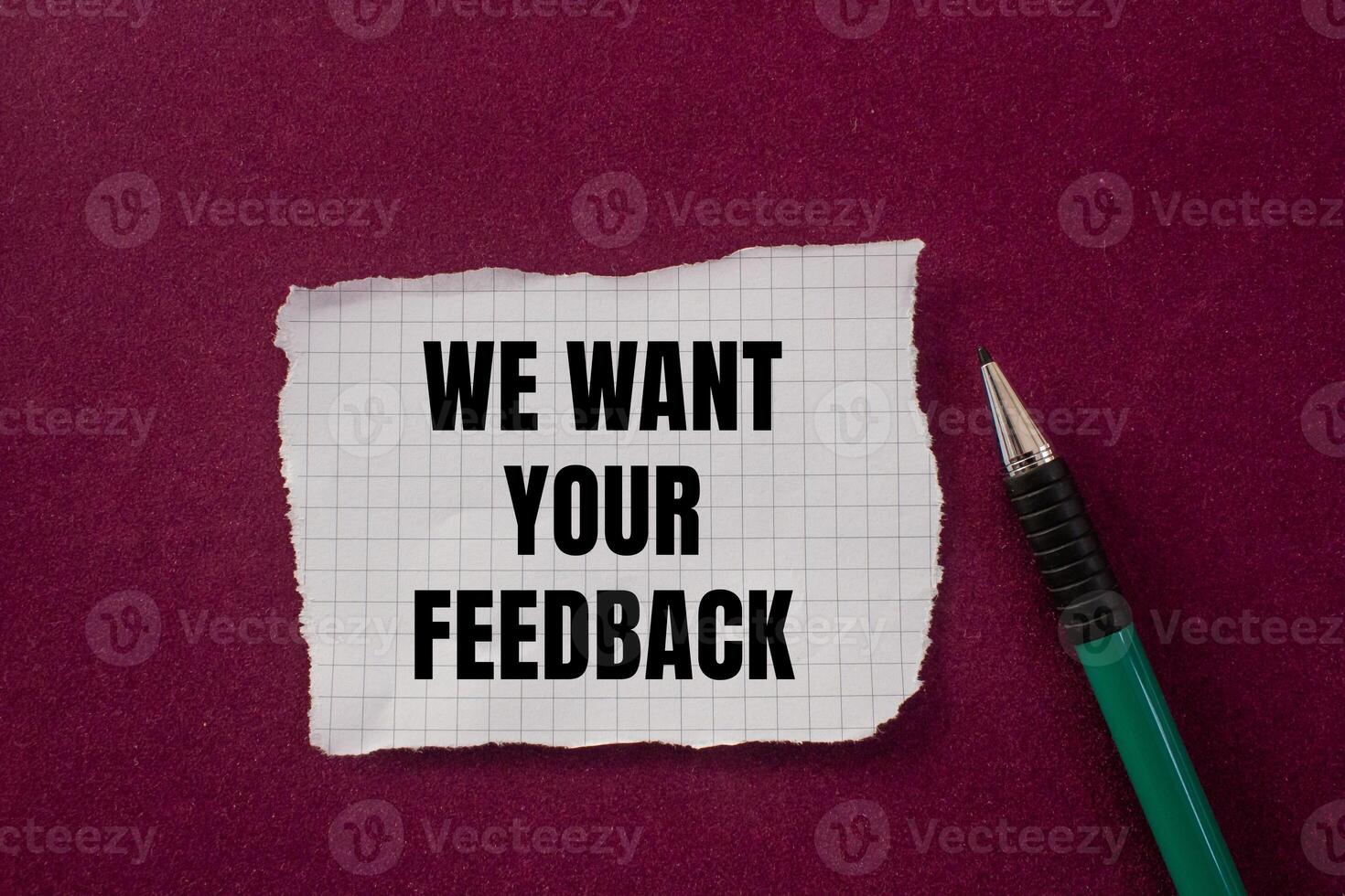We want your feedback message written on ripped torn paper with a pen on purple background. Conceptual we want your feedback symbol. Copy space. photo