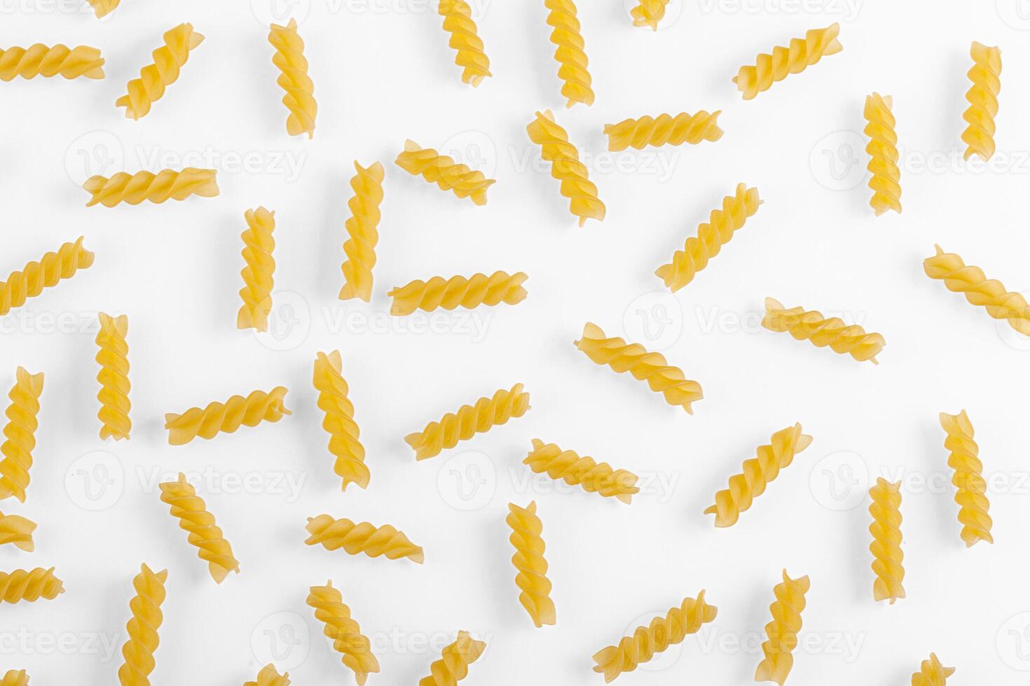 Pasta products in the form of a spiral, texture, on a white background photo