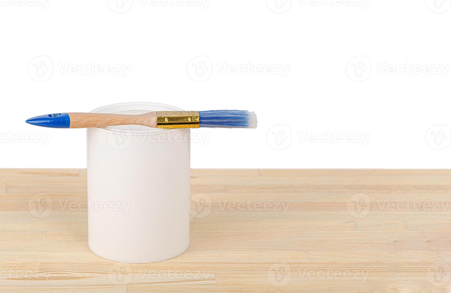 white paint with a brush on a wooden background with texture photo