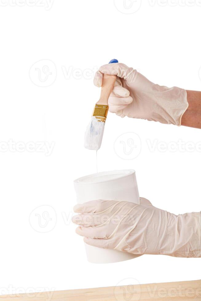 white paint with a brush painting a wooden background with texture photo