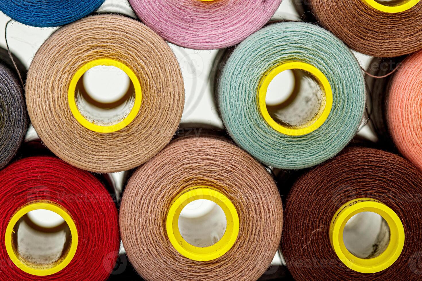 set of multi-colored spools of thread for sewing photo