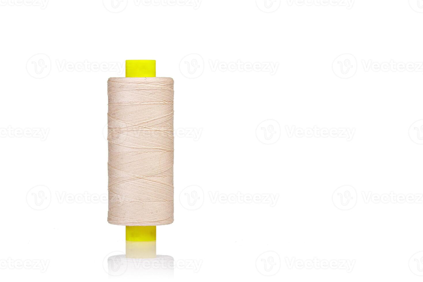 skein of beige color thread macro on a white background photo