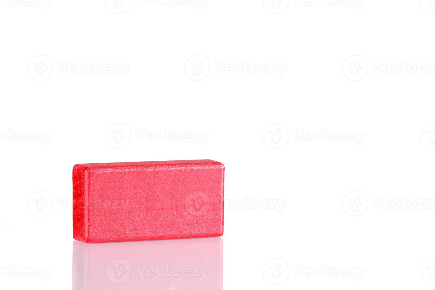 Wooden cube of red color on a white background photo