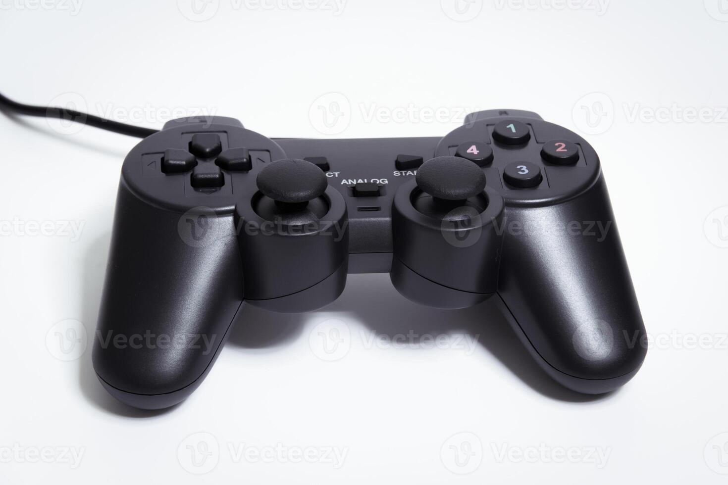 Black controller on white background, game device, Joystick on a white background. photo