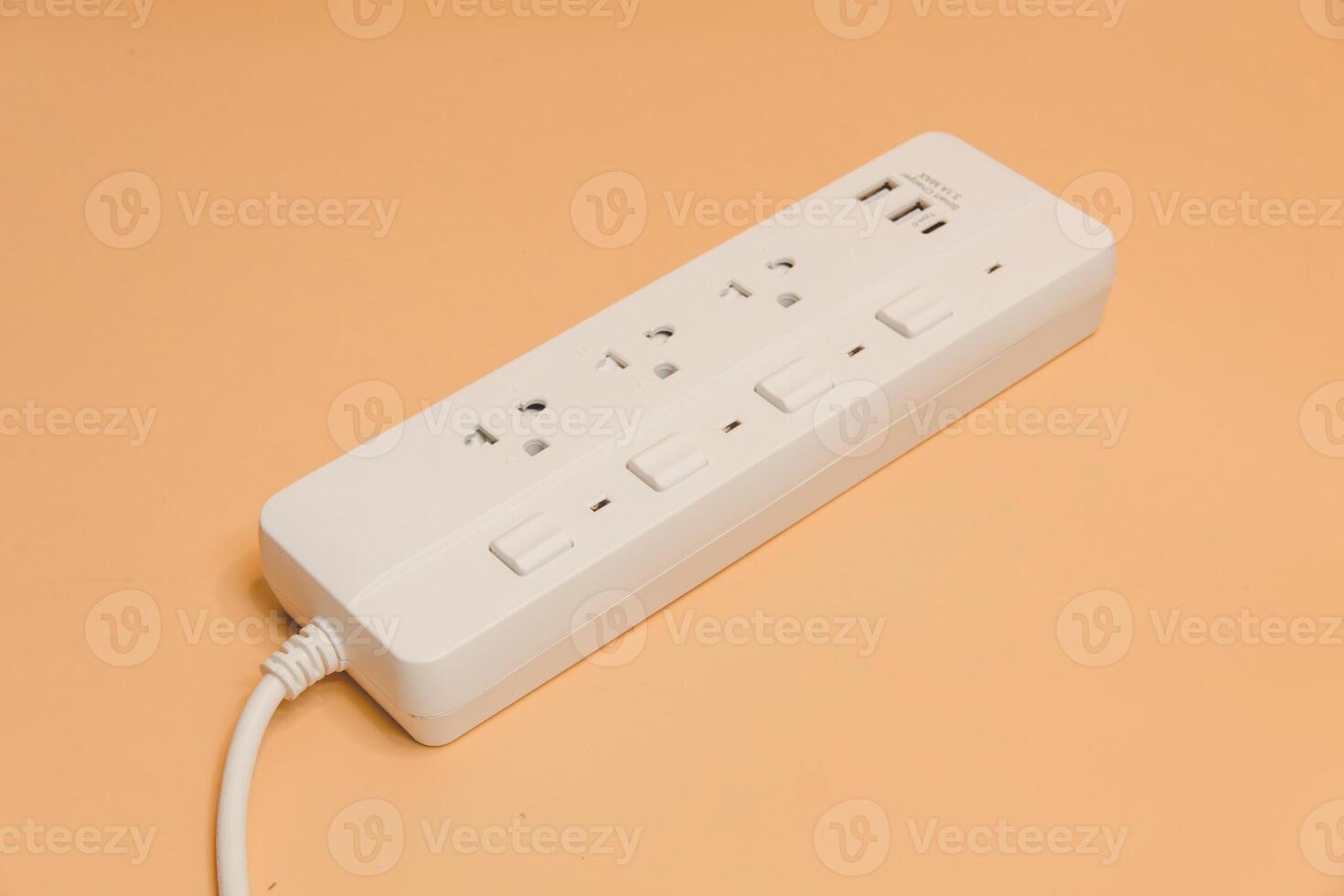 Electrical plug in outlet socket at home, Electrical plug in outlet socket at home, Energy efficiency concept, Power strip with extension cord on beige background, top view. photo