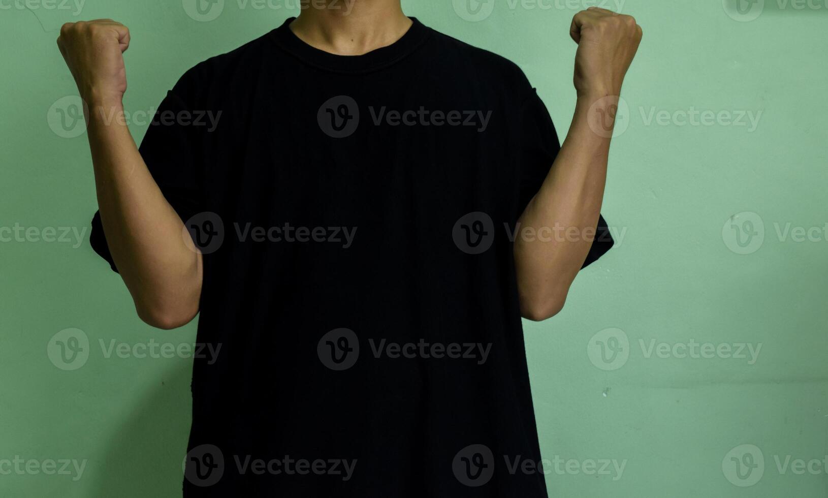 Young confident man pointing to himself isolated on green background photo