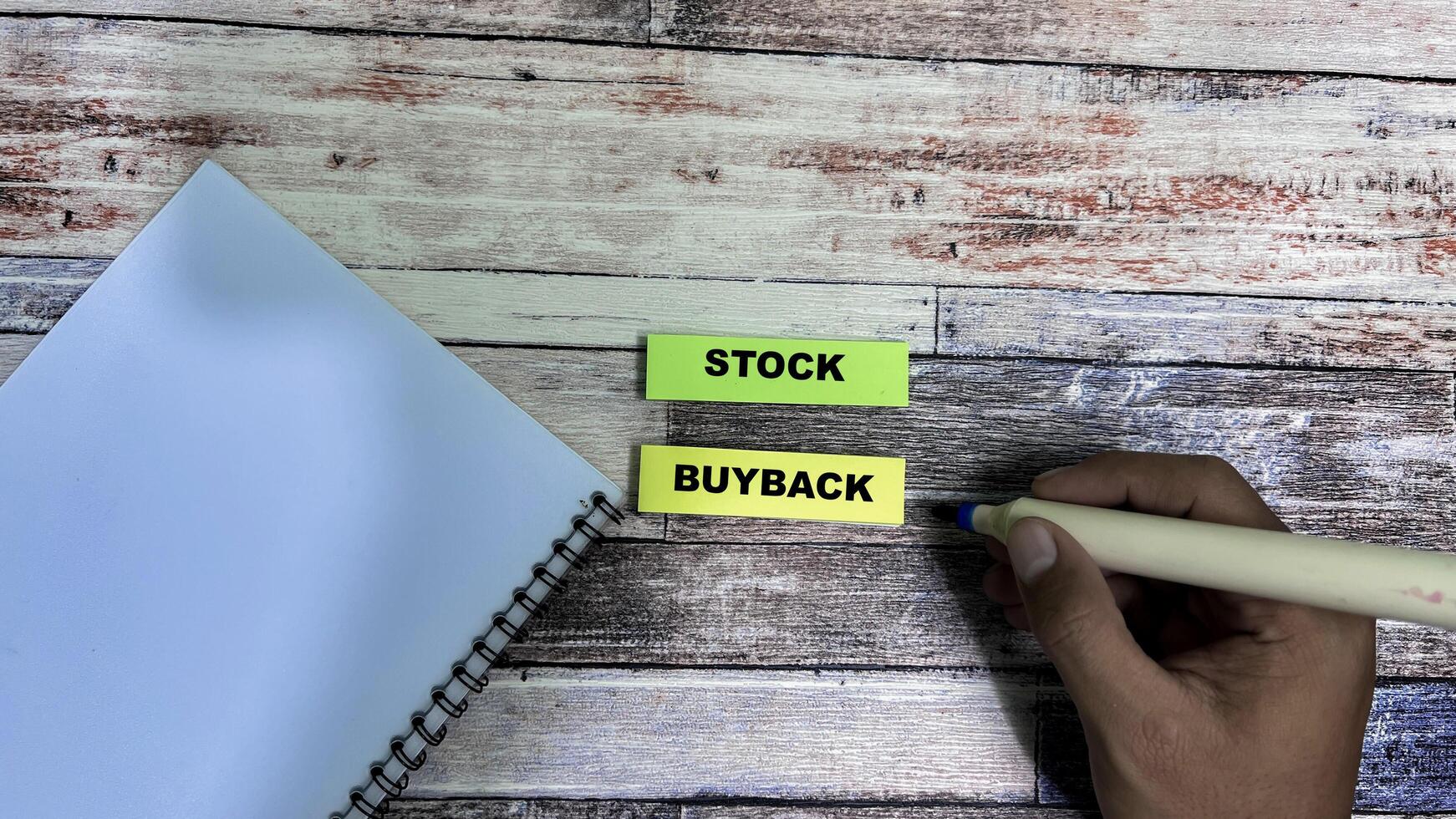 Concept of Stock Buyback write on sticky notes isolated on Wooden Table. photo