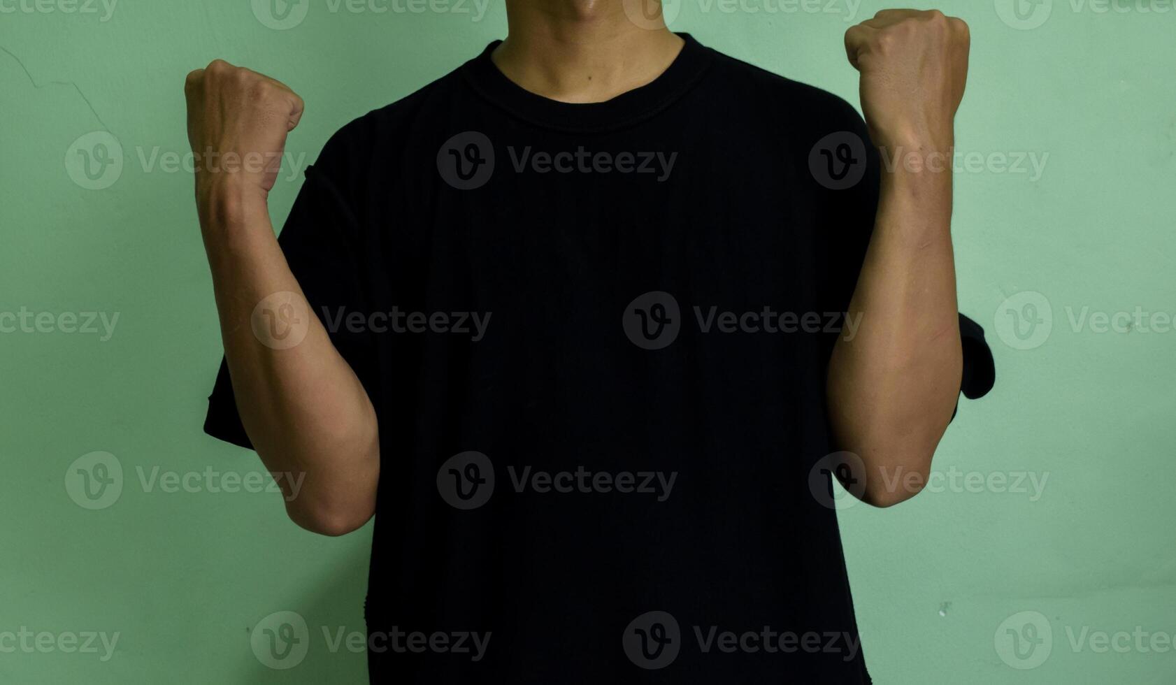Young confident man pointing to himself isolated on green background photo