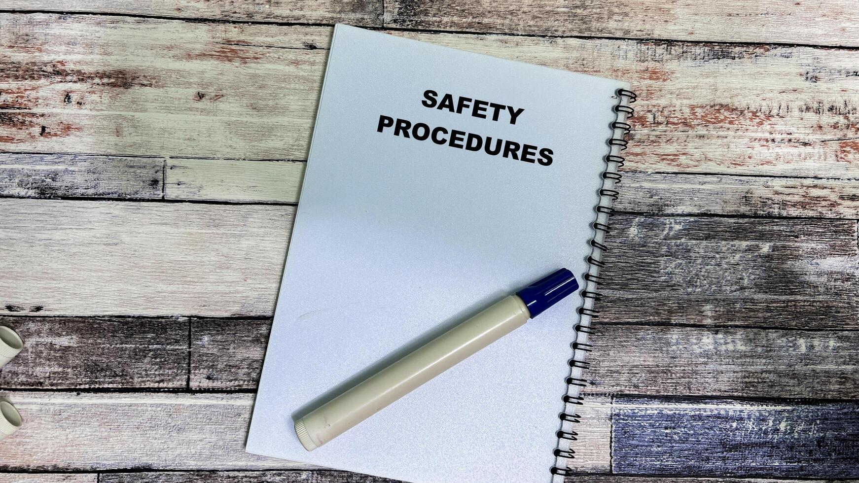 Concept of Safety Procedures write on book isolated on Wooden Table. photo