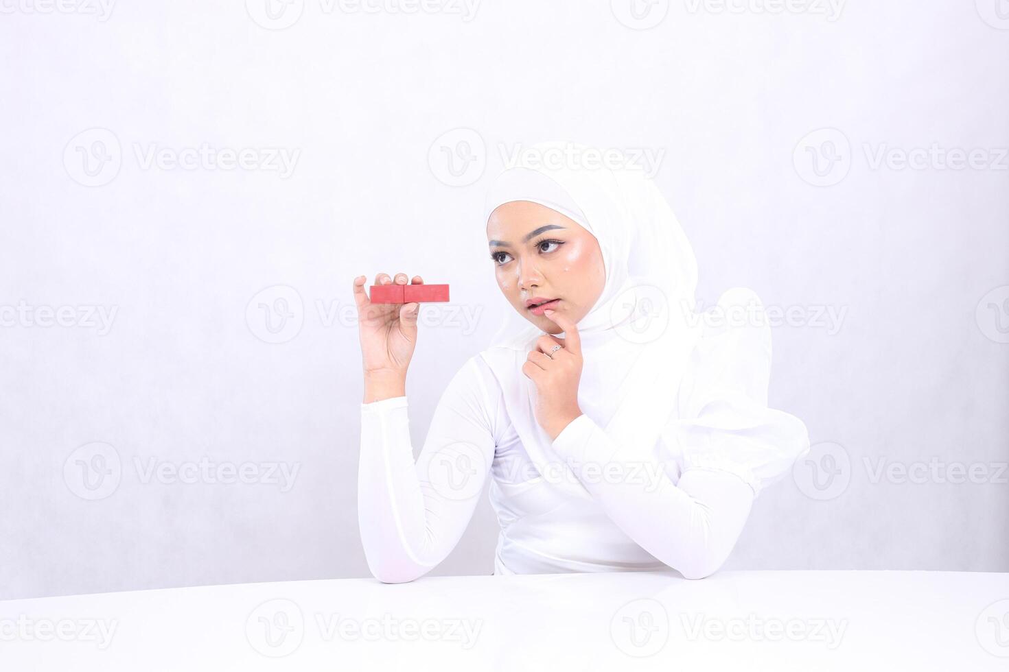 Lip Makeup View Beautiful Woman veil Sharp Look Right Top Hand Clamping Sideways Lipstick Container And Sticking Lips Isolated White Background. Cosmetic Promotion, Lip Care,Lipstick Container Mock Up photo