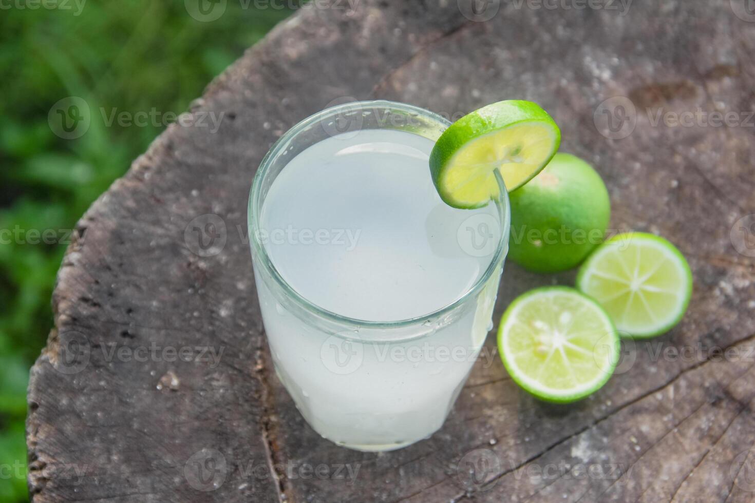 Fresh coconut water from yellow coconuts added with lime juice photo