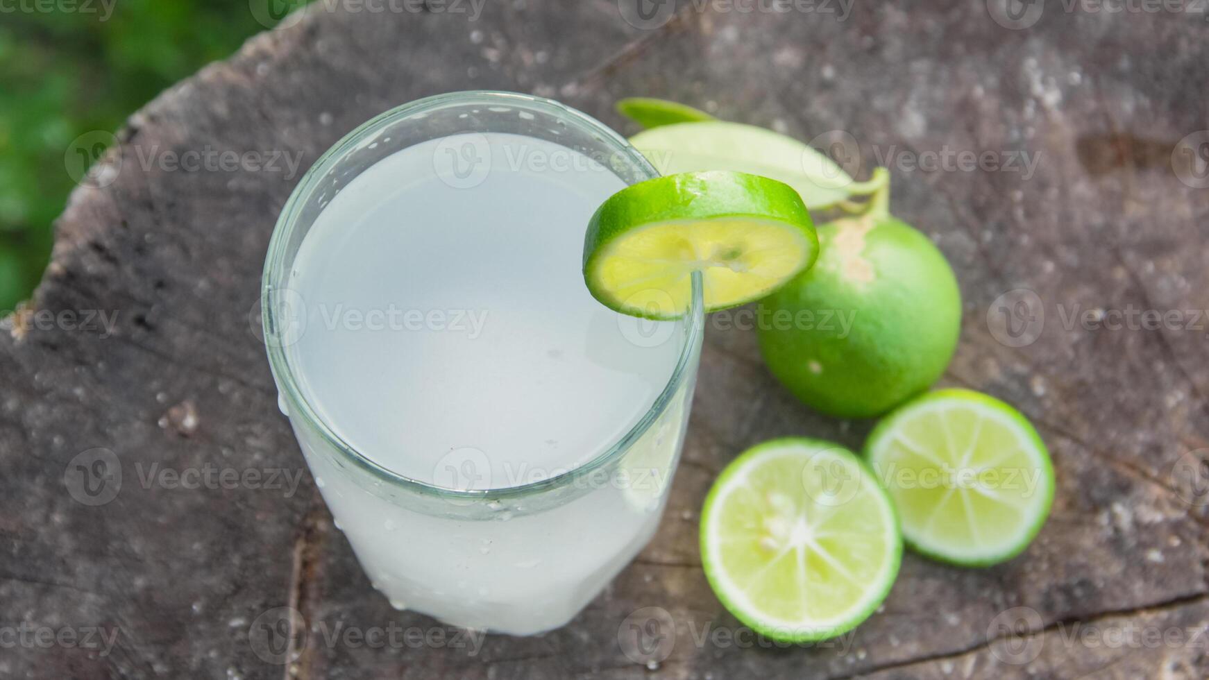 Fresh coconut water from yellow coconuts added with lime juice photo