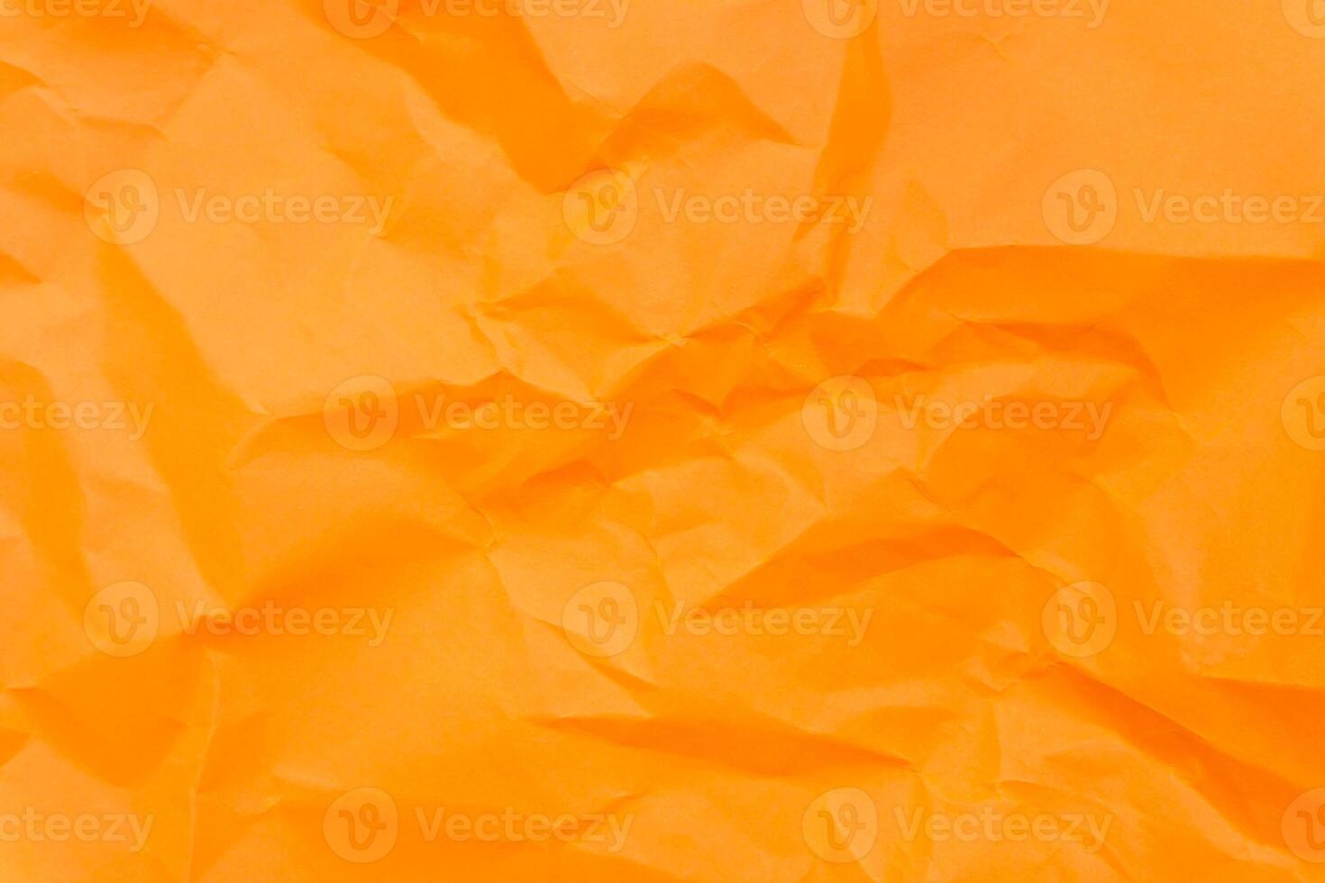Top view and full frame of wrinkled or crumpled orange paper texture used as crumpled paper background texture in decorative art work photo