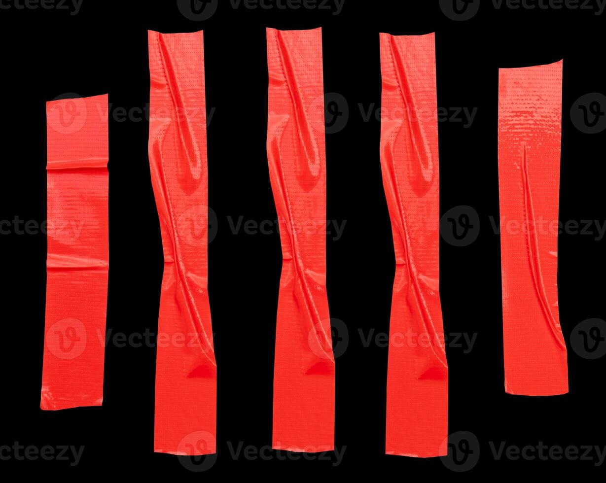 Top view set of red adhesive vinyl tape or cloth tape in stripes isolated on black background with clipping path photo