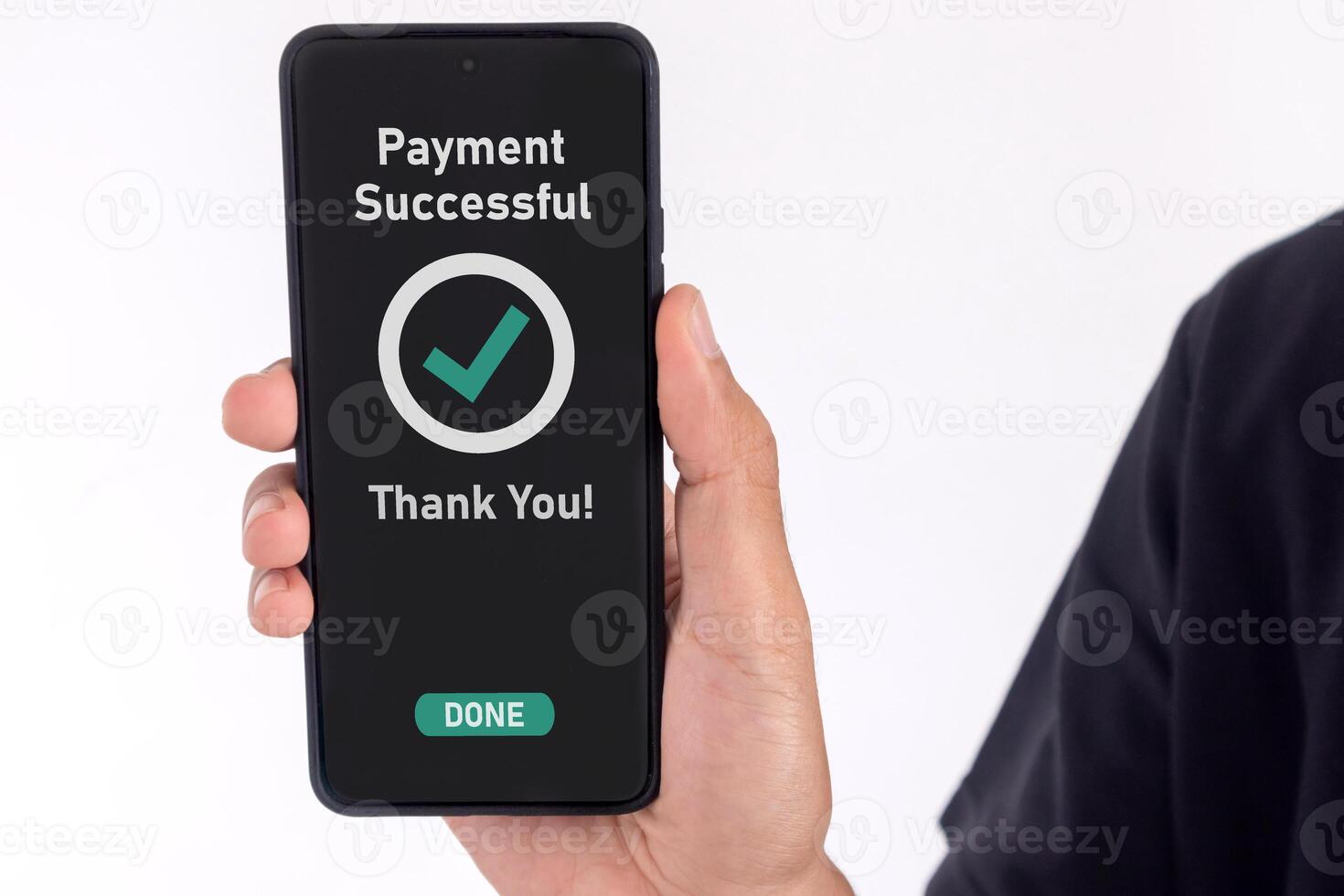 Male hand holding a mobile phone showing successful payment message photo