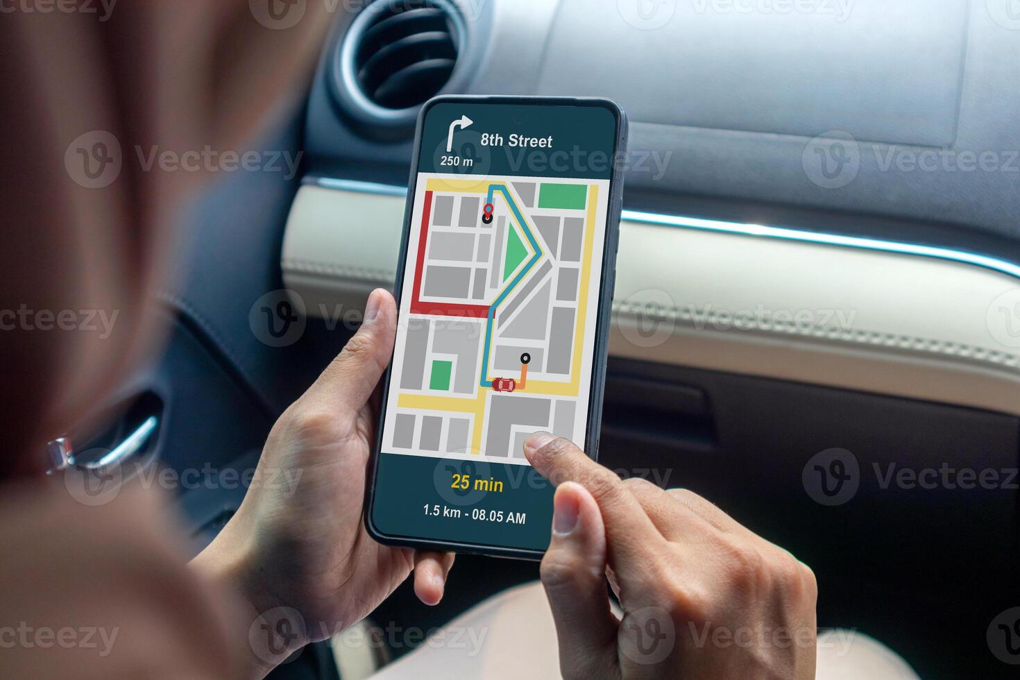 Woman in a car holding a mobile phone with a GPS navigation map photo