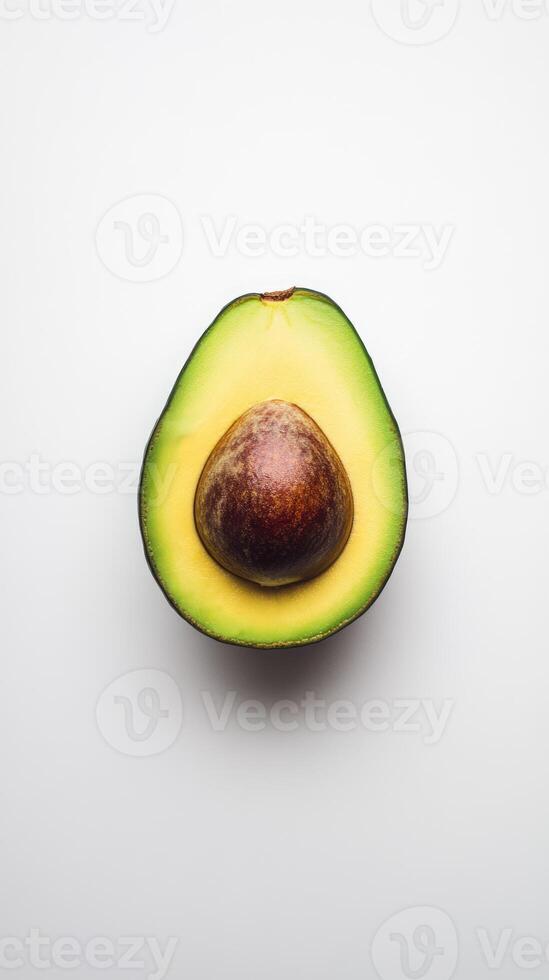 Avocado half isolated on white background. Fresh ripe cut green fruit with a pit photo
