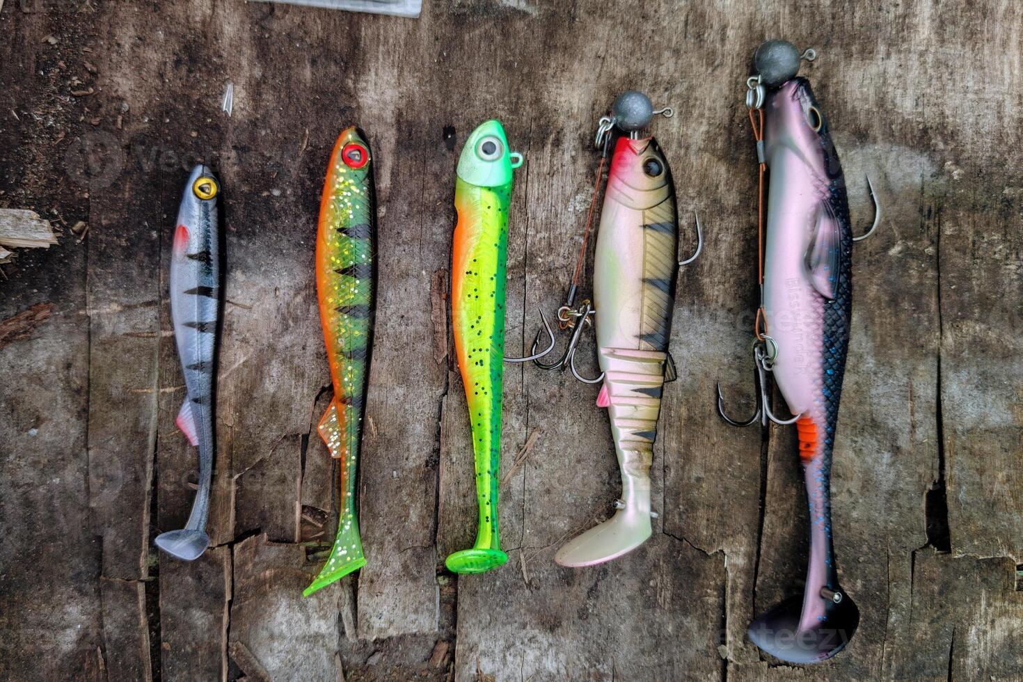 Fishing lures set, spinning ger, angling, sport fishing, catch and release, fish bait isolated on aged wood background photo