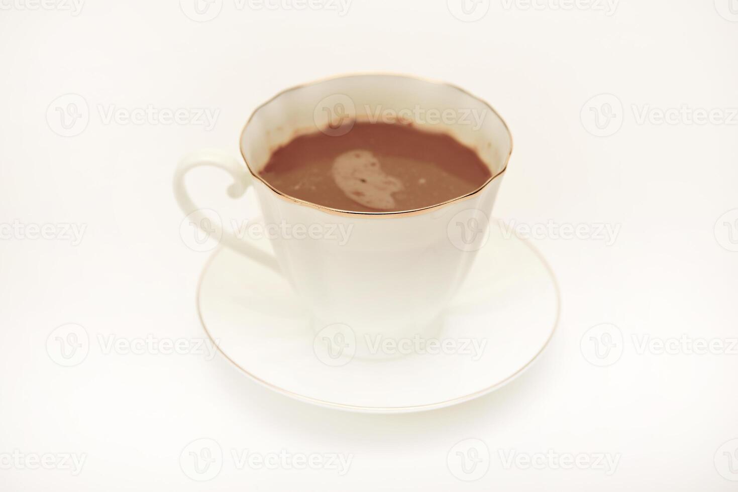 A white cup and saucer with coffee on a white background. photo