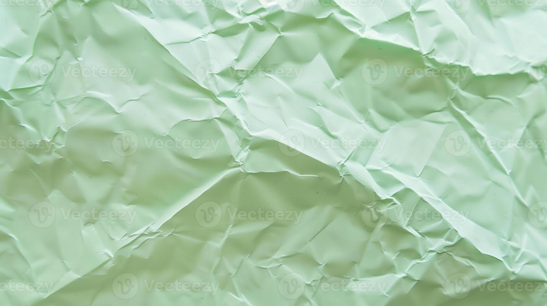 Close-up of wrinkled green paper texture, ideal for scrapbooking and crafting. Top view photo
