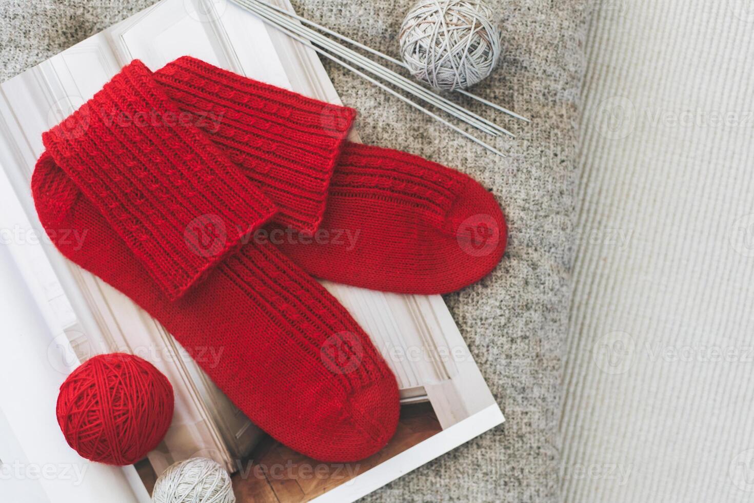 Hand knitted socks with needles and yarn ball. Concept for handmade and hygge slow life. photo