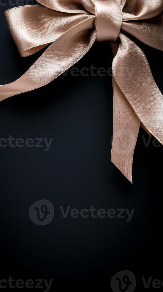 A black background with a ribbon bow elegantly tied and placed in the upper corner, creating a luxurious gift feel with empty space photo