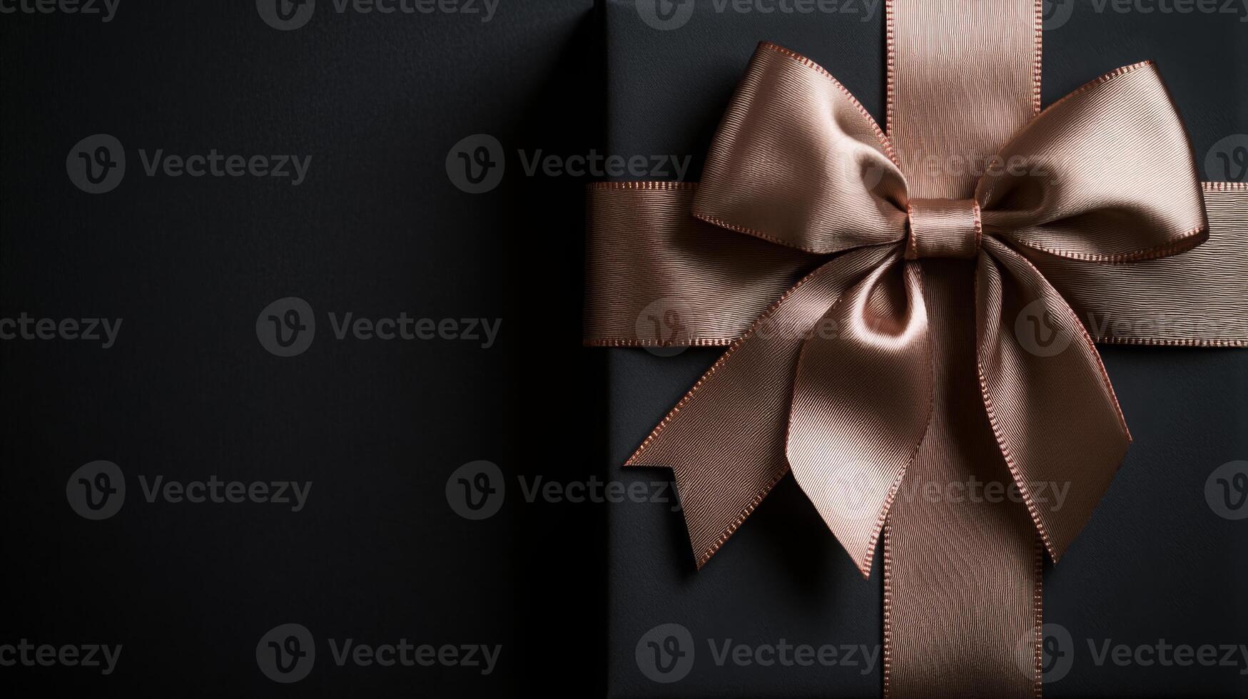 A black background with a ribbon bow elegantly tied and placed in the upper corner, creating a luxurious gift feel with empty space photo