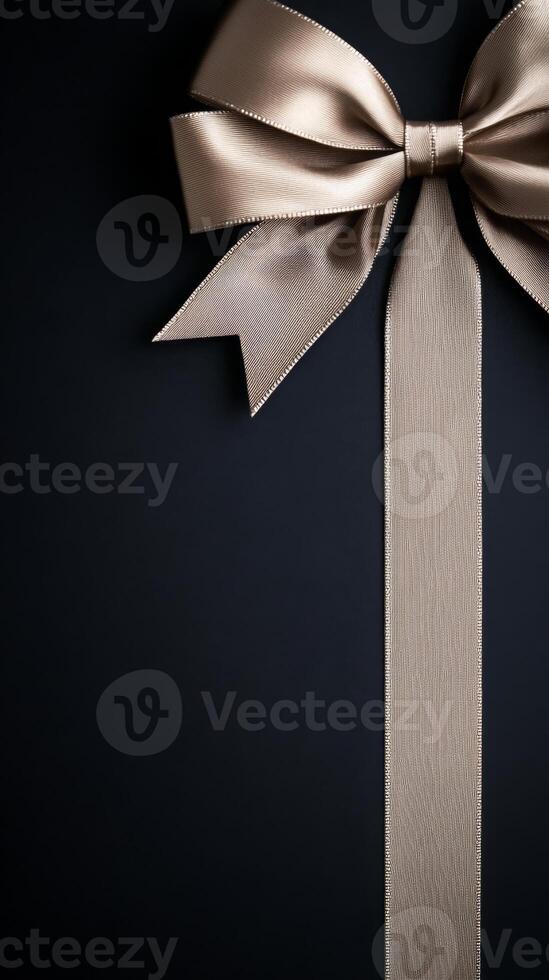 A black background with a ribbon bow elegantly tied and placed in the upper corner, creating a luxurious gift feel with empty space photo