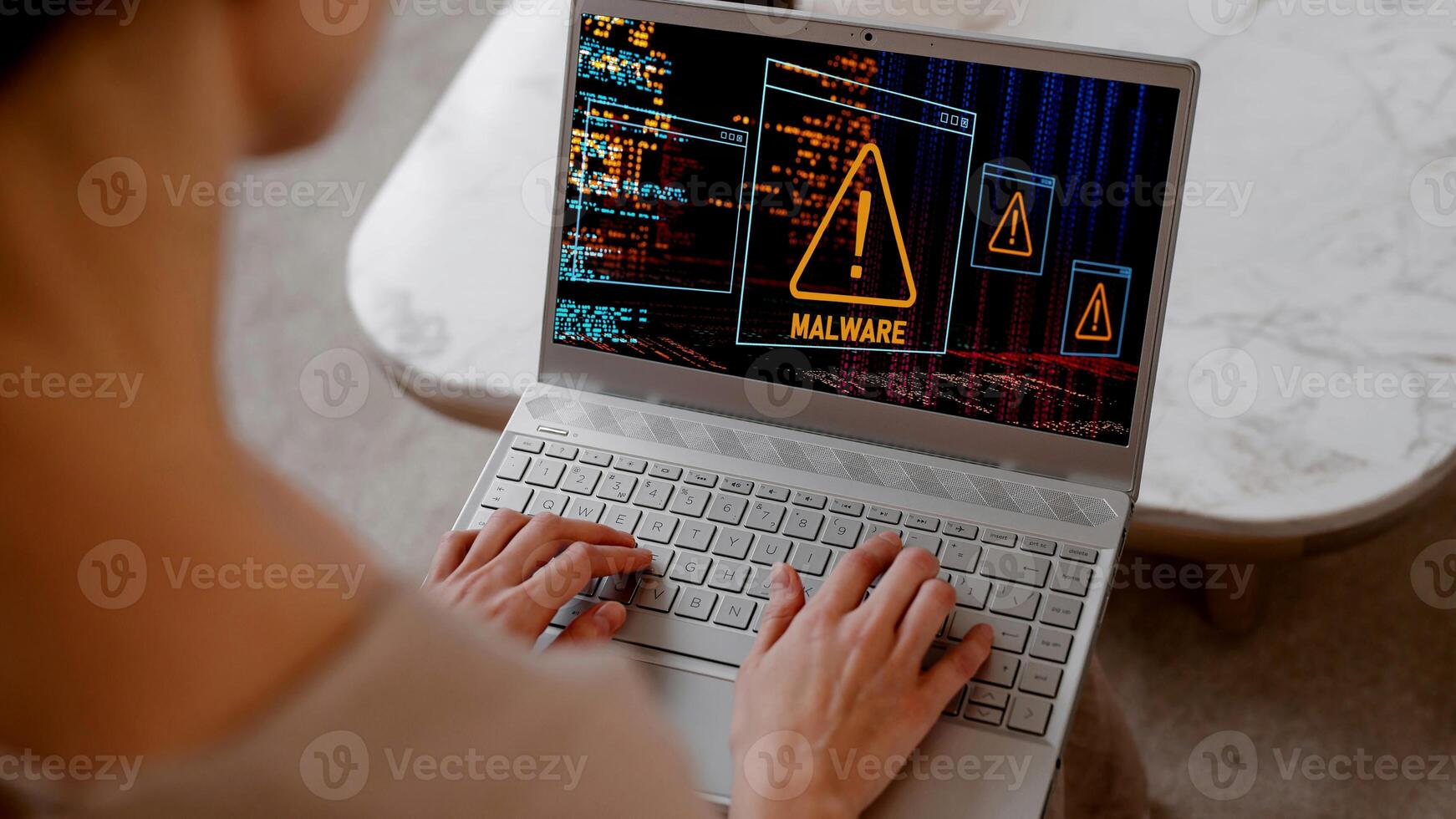 A man using laptop in his home and getting warning alerts on screen, Cyber attack on computer network photo