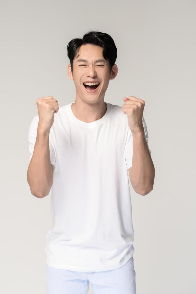 Portrait of young smiling asian man over white background photo