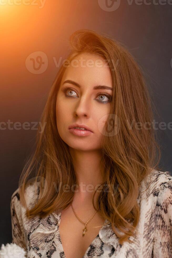 Portrait of a beautiful young business woman standing against grey background photo