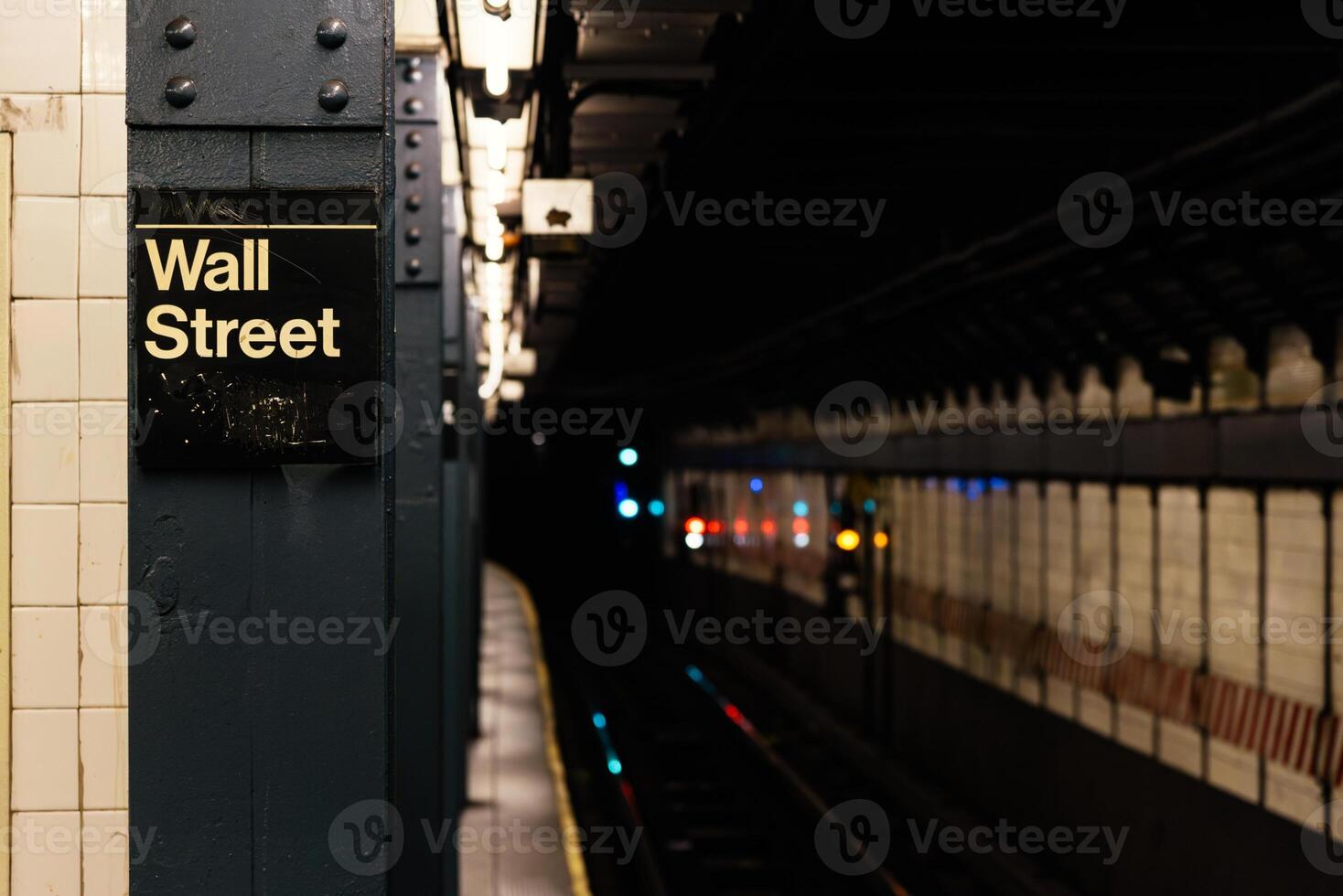 Wall street sign in empty subway photo