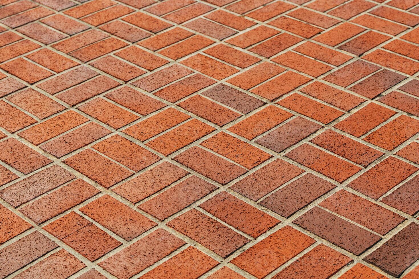 Texture of orange brick pavement in perspective as background photo