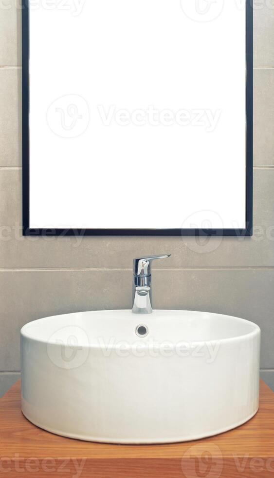 Washbasin in modern bathroom with mirror on the wall photo