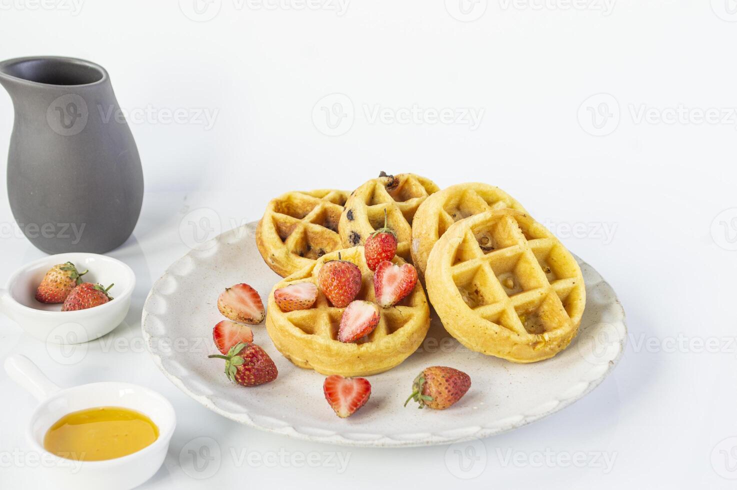 a waffle with strawberries on a plate photo