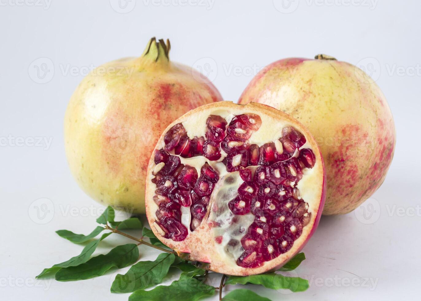 pomegranate with leaves on white background photo