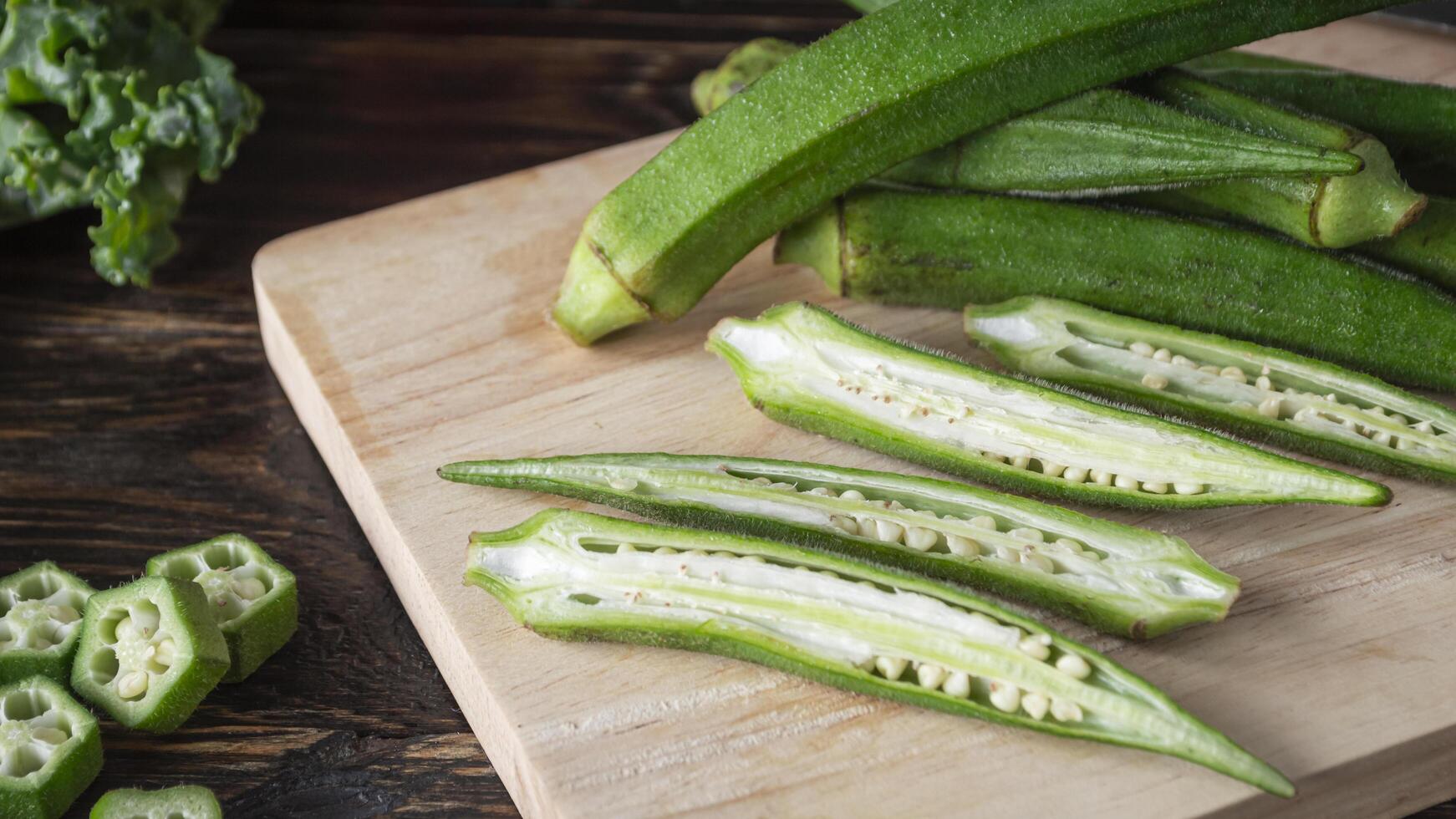 a wooden cutting board with a bunch of okra photo
