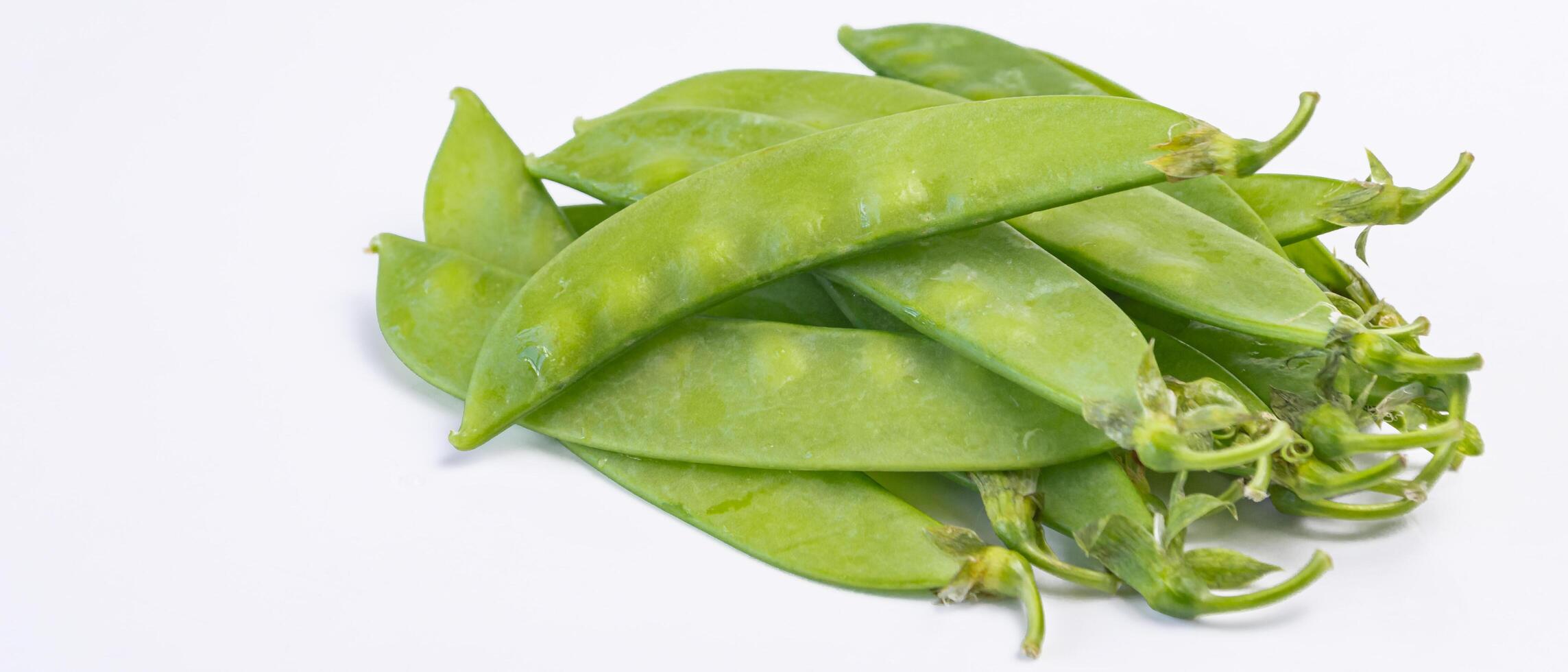 a pile of green peas on a white background photo