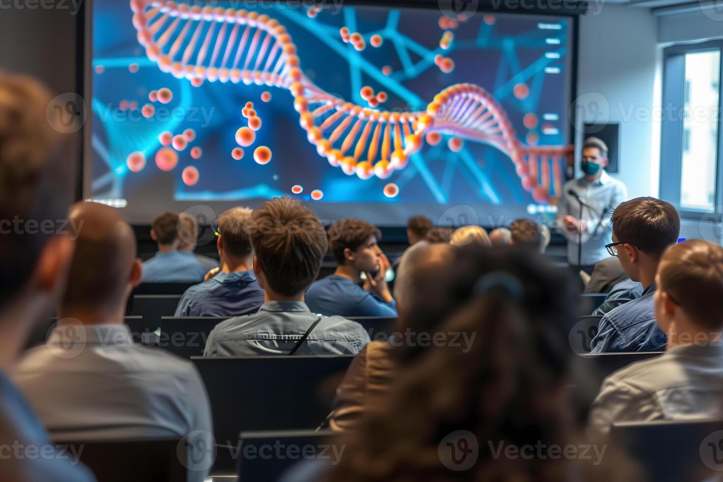 In a vibrant lecture hall a group of attentive students is captivated by a large screen displaying an educational film on DNA photo