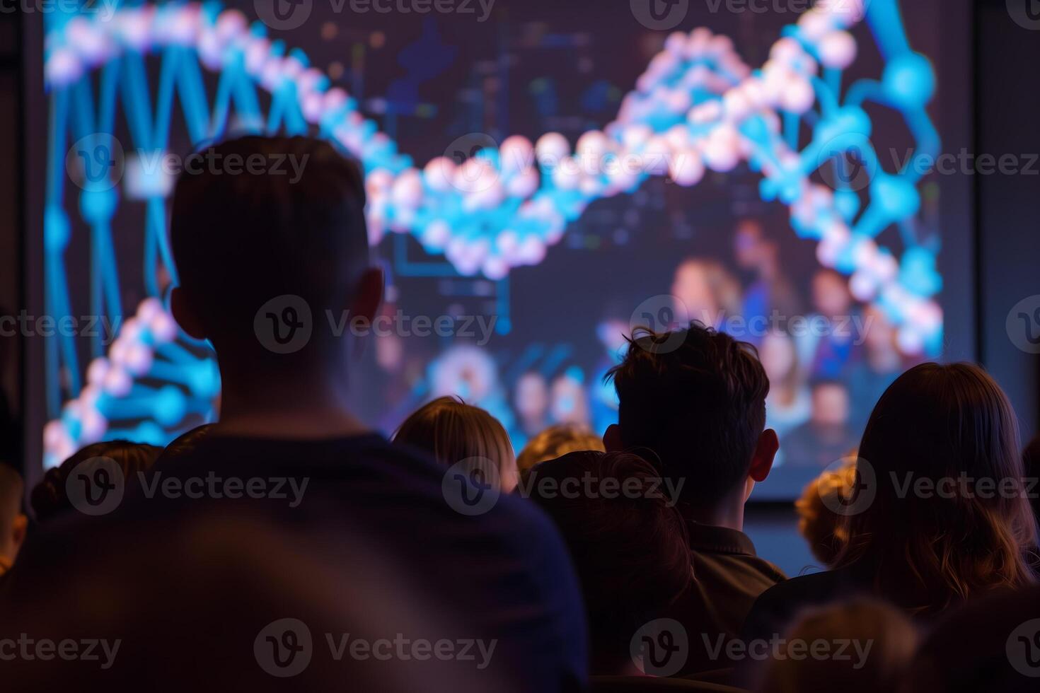 A group of students is captivated by a large screen displaying an educational film on DNA, modern technology enhances the understanding of complex genetic concepts photo