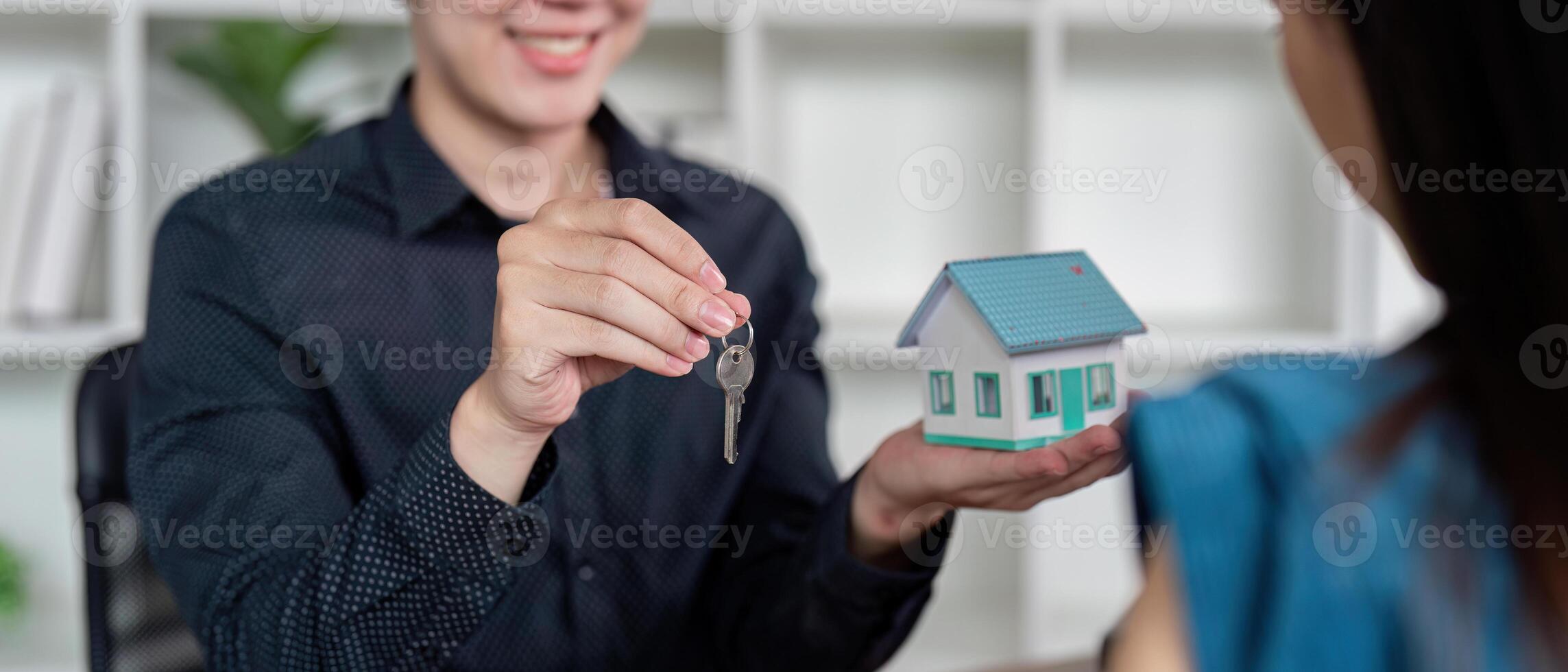 Real estate agent handing over keys to new homeowner 49753863 Stock