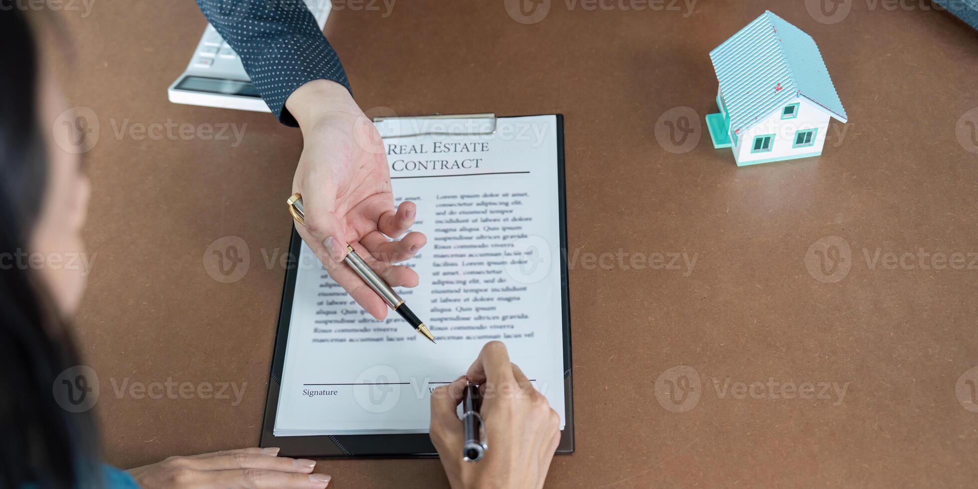 Finalizing a real estate deal with a signature photo
