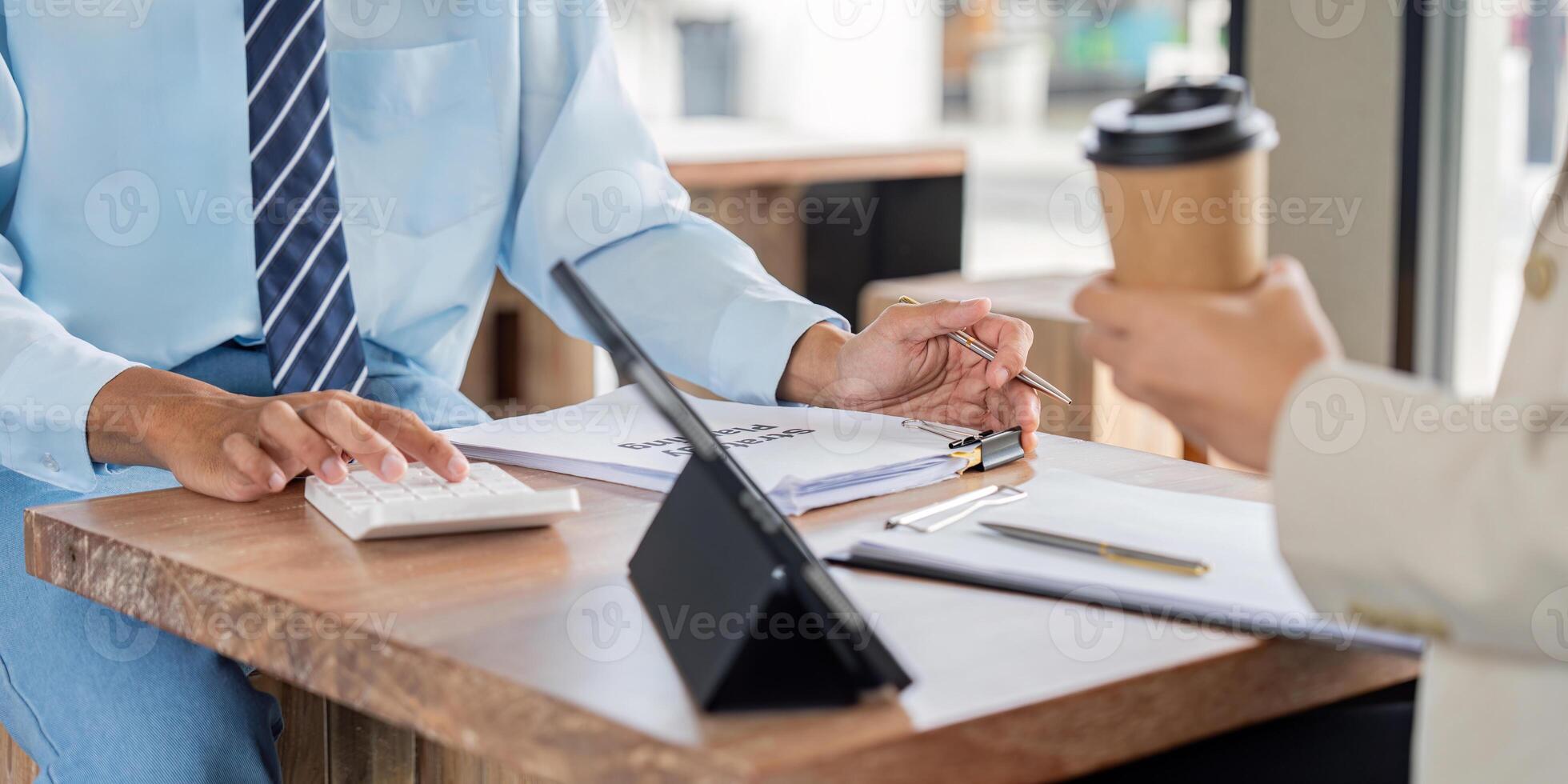 Professional team reviewing financial reports in cafe setting photo