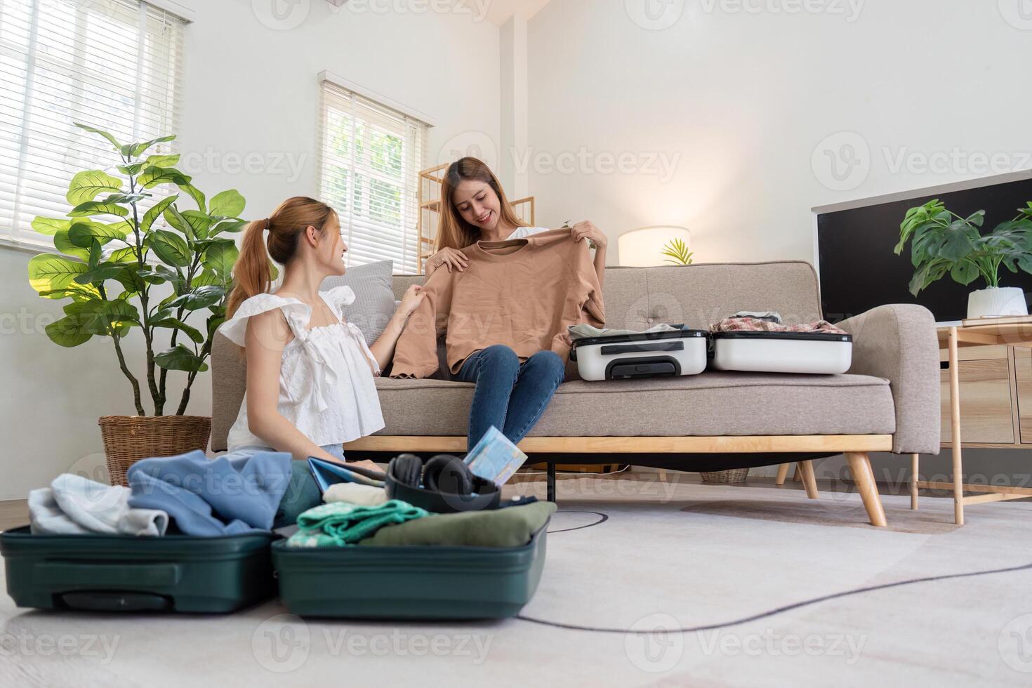 Women selecting outfits for upcoming travel adventure photo