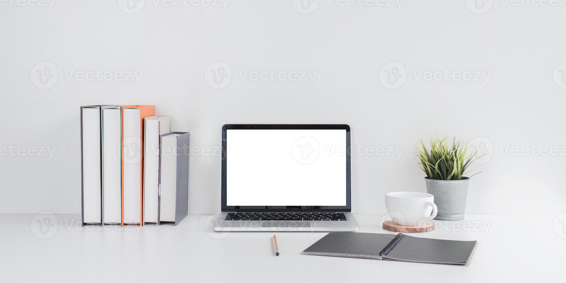 Minimalist Workspace with Laptop and Books on Desk photo
