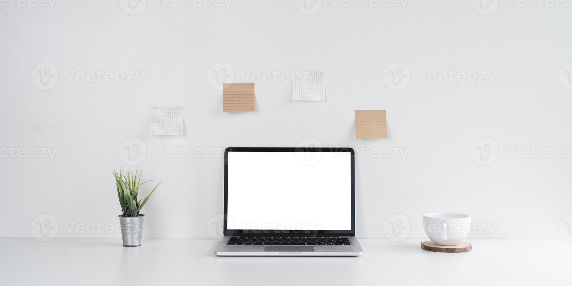 Simple Workspace with Laptop and Coffee Cup on Desk photo