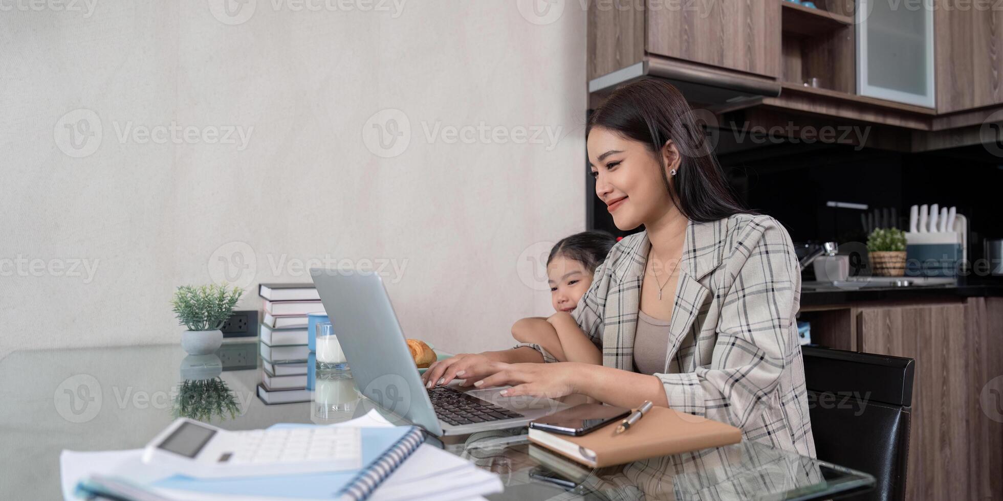 Mother Working from Home with Daughter. Balancing Remote Work and Parenting photo