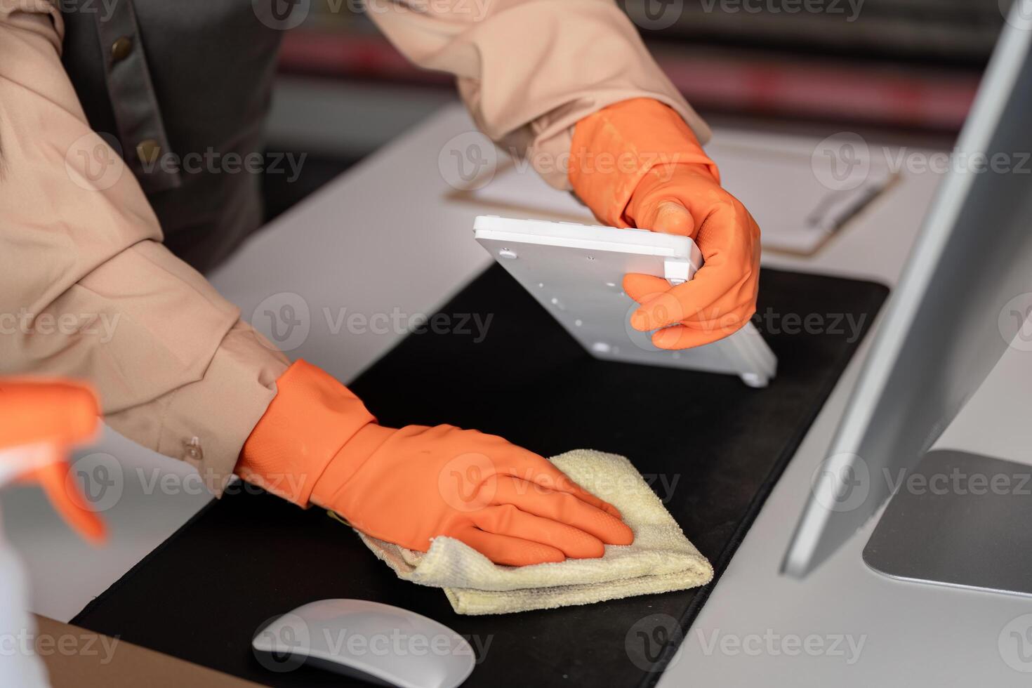 Office cleaning with attention to keyboard and care photo